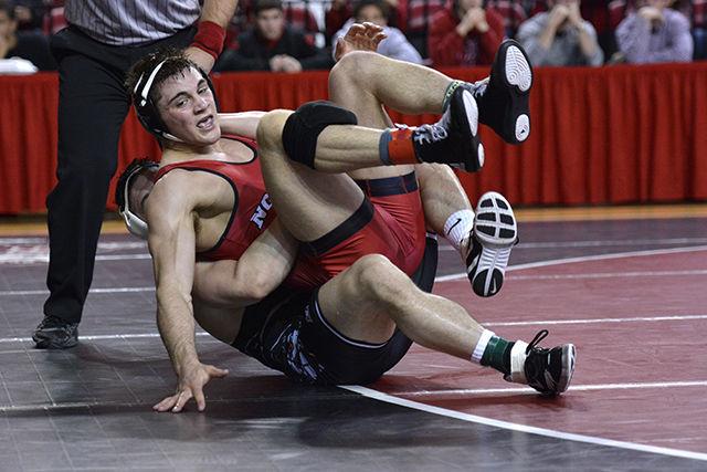 Sophomore Pete Renda (174 lb.) is rolled across the mat by opponent Kyle Crutchmer during No. 20 NC State's match with No. 6 Oklahoma State Feb. 22, 2015 in Reynolds Coliseum. Renda lost the bout by decision 5-3 - 0-3. Despite strong performances by redshirt junior Nick Gwiazdowski and redshirt freshman Joe DeAngelo, the Wolfpack was defeated 20-12.