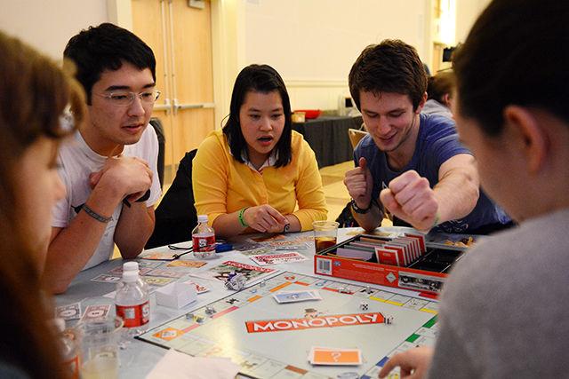 Jason Suttles (left),a senior studying philosophy and computer science; Angel Ngo (middle), a sophomore studying biological sciences and Mitchell Martin (right), a freshmen studying microbiology, participate in the Roomopoly event hosted by University Housing. The event took place in the Talley Student Union Mountains-Piedmont Ballroom.
