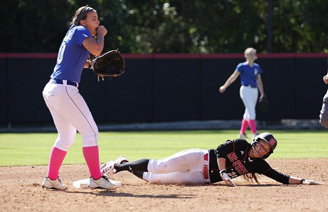 Senior shortstop Renada Davis slides into second as the Pitt Community College second baseman reacts to their pitcher getting hit in the head with a softball. The Wolfpack beat Pitt Community 3-1 in the first game of the doubleheader Oct. 25th, 2014.