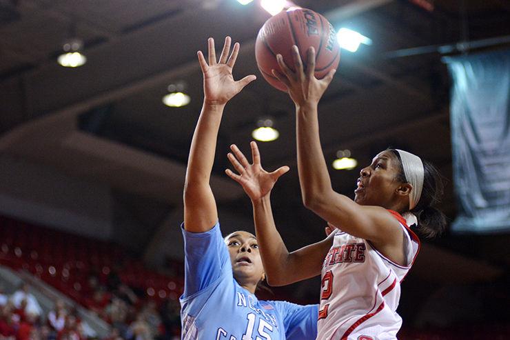 Redshirt senior Len'Nique Brown-Hoskin is challenged by Carolina's Allisha Gray as she glides to the basket for a layup during the rivals' game Jan. 22 in Reynolds Coliseum. Brown-Hoskin led the Pack in scoring with 21 points, while also contributing three assists and three steals. Despite leading for nearly 33 minutes of regulation time, the Pack lost the contest, 67-63.