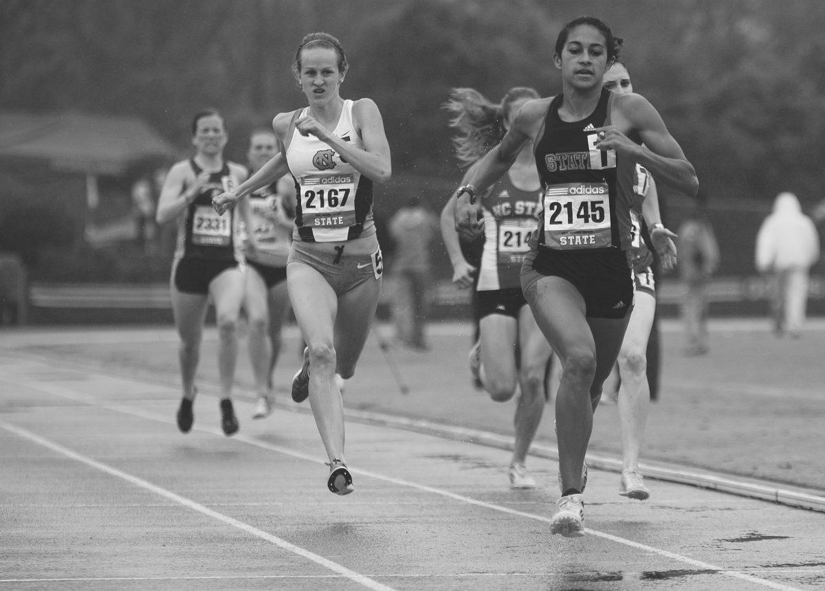 Red Shirt Ryanna Henderson sprints for the finish of the women's 200 meter dash. Ryanna finished in ninth place with a time of 2 minutes and 13.97 seconds. The 2014 Raleigh Relays were held at Dale Soccer Field Friday and Saturday. Photo by Joseph Phillips