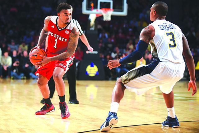 Redshirt junior guard Trevor Lacey fakes out a defender during the basketball game against Georgia Tech in the McCamish Pavilion in Atlanta on Saturday. Lacey sealed the Wolfpack's 81-80 victory with a three-point buzzer-beater in overtime.