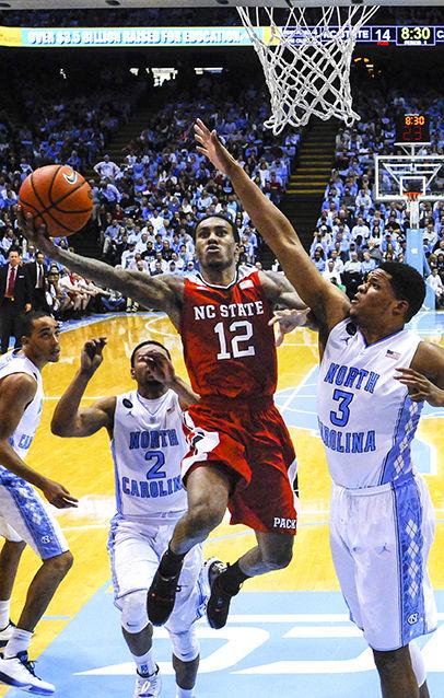 Sophomore guard Anthony 'Cat' Barber glides to the rim past the outstretched arm of North Carolina's Kennedy Meeks for a layup Tuesday, Feb. 24, 2015, at the Dean E. Smith Center. Barber led the Pack in scoring with 15 points and also had 4 assists and 4 rebounds in NC State's 58-46 win over the Tar Heels. The win was the Wolfpack's first at UNC since 2003, and its first over a Roy Williams-led Tar Heel squad.
