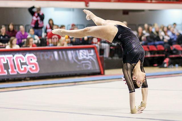 Senior Lane Jarred raises herself from the floor with an acrobatic move during the floor exercises on senior night Feb. 20 in Reynolds Coliseum. Jarred scored a 9.750 as the Pack took home third place behind UNC-Chapel Hill and Kent State but ahead of Rutgers.