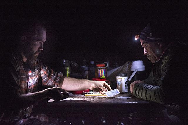 Alex Davis, a senior studying electrical engineering, plays cribbage with Terry Dash, outdoor recreation instructor and director of NC State's outdoor leadership program, Saturday evening at their campsite along the New River just outside of Fayetteville, WV. Davis, along with nine other students in Dash's whitewater rafting course, spent the weekend putting the skills they had learned in class to the test on the rapids of the New. "It was nice to relax after a long day of paddling," said Davis in regard to the card game.
