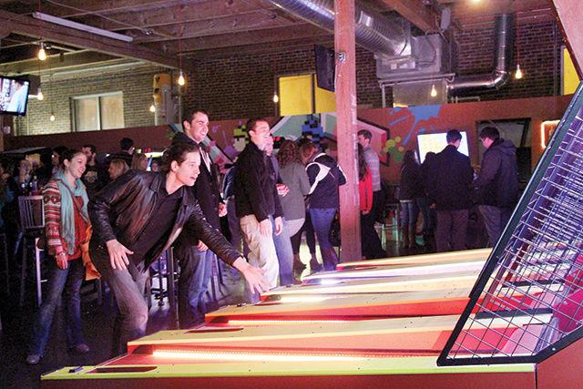 Michael Rountree, a resident from Durham plays skee-ball at the Boxcar Bar + Arcade. The customers at this bar not only get to enjoy an occasional drink during the weekend with friends but also get to revisit their childhood by playing different games.