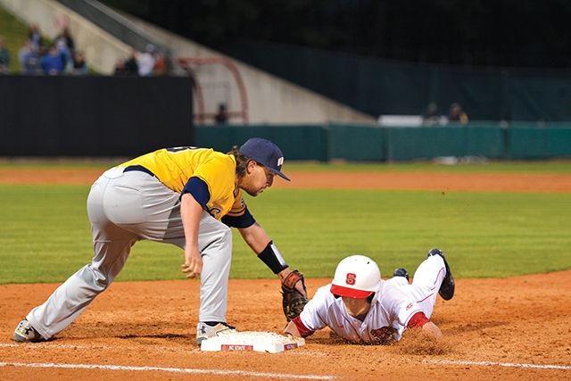 Freshman outfielder Brock Deatherage dives towards the base at the game against UNC-Greensboro on March 18 at the Doak Baseball Field.
