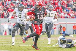Redshirt Junior quarterback Jacoby Brissett scrambles for a 9 yard run during the final home game against Wake Forest in Carter-Finley Stadium Saturday, Nov. 15, 2014. Brissett threw for 83 yards in the Wolfpack's 42-13 defeat of the Demon Deacons. Photo by Ben Salama.