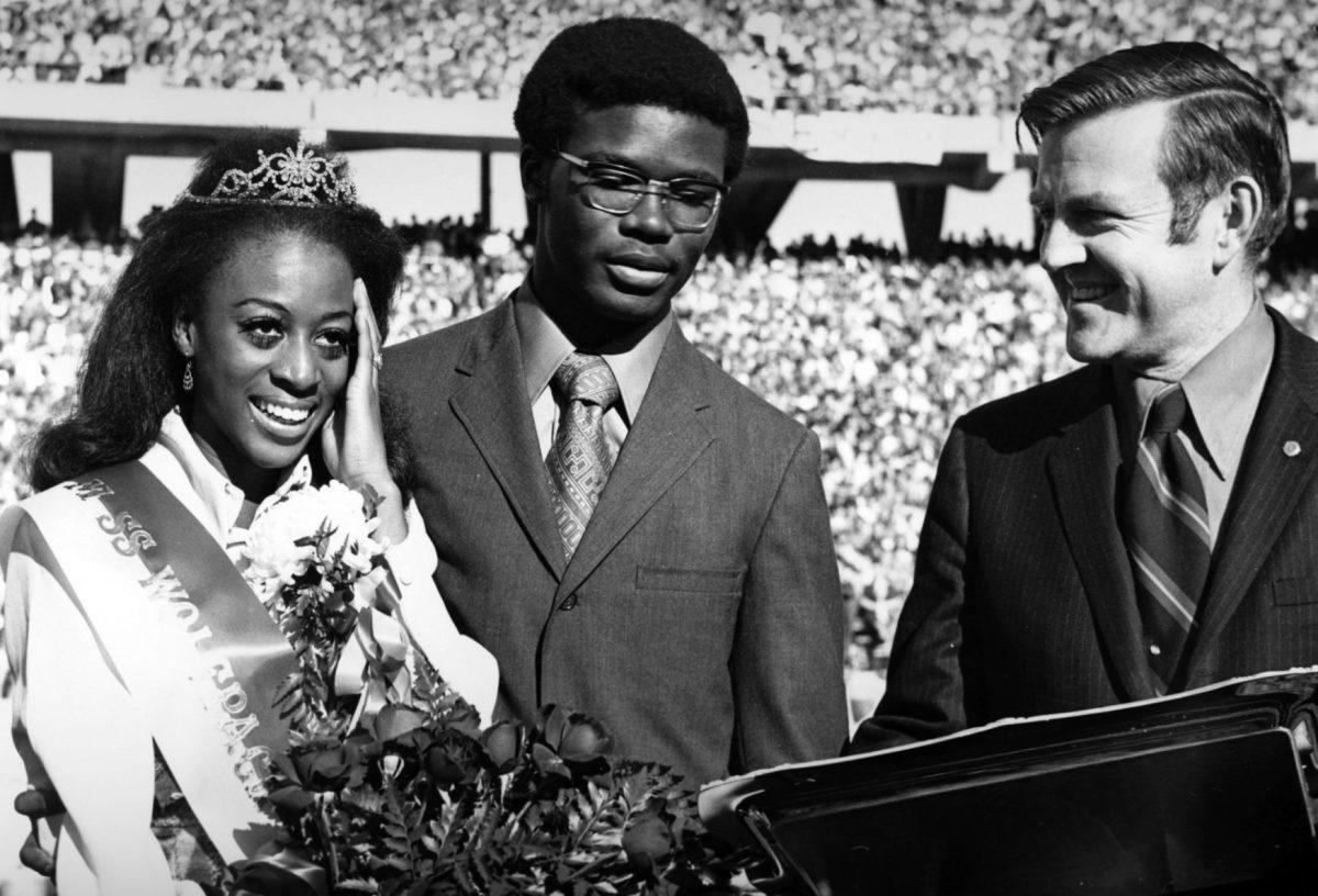 Mary Evelyn Porterfield is crowned the 1970&#160;Homecoming Queen. Porterfield was the first African- American woman to be crowned Homecoming Queen at NC State. Her escort, Michael Brown, and Bryce Younts, former director of NC State University Alumni Affairs Office, stand to the right.