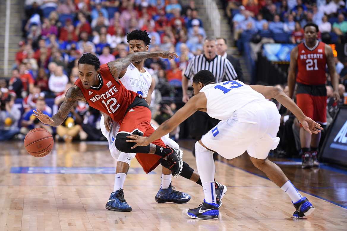 Sophomore guard Anthony &#8220;Cat&#8221; Barber trips after splitting two Duke defenders during the quarterfinal game of the ACC Tournament at the Greensboro Coliseum Thursday. The No. 2 Blue Devils crushed the Wolfpack, 77-53.