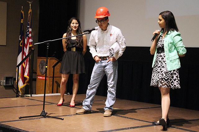 Carlos Vega, senior in civil engineering, who won the competition being escorted by Jessica Gallo, junior in social work and introduced by Apoorva Thatavarty, sophomore in chemical engineering at the Crown the Engineer fundraising event on March 25, 2015 at Witherspoon Student Centre. The annual event organized by Society of Woman Engineers raises money for relay for life.