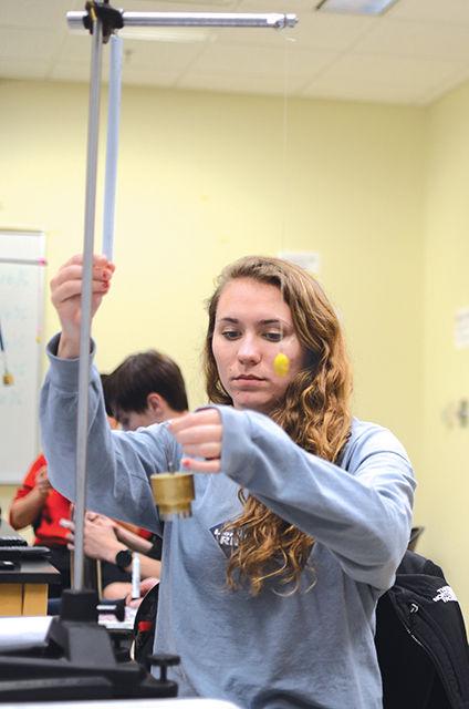 Rachel Evans, First Year Enginner, and Wyatt Maxie, First Year Engineer, conduct a physics experiement in Fox Hall on Feburary 23rd. Physics is a general education requirement for engineering majors. "I decided to I wanted to be an enginner because I like problem solving and math." said Evans.