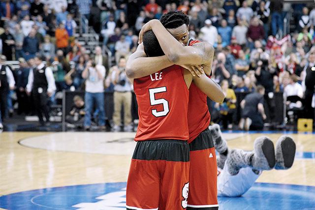 Sophomore forward Beejay Anya hugs senior guard Desmond Lee during the third round game of the NCAA tournament against Villanova at the Consol Energy Center in Pittsburgh, PA. The Wolfpack defeated the 1-seed Wildcats 71-68.