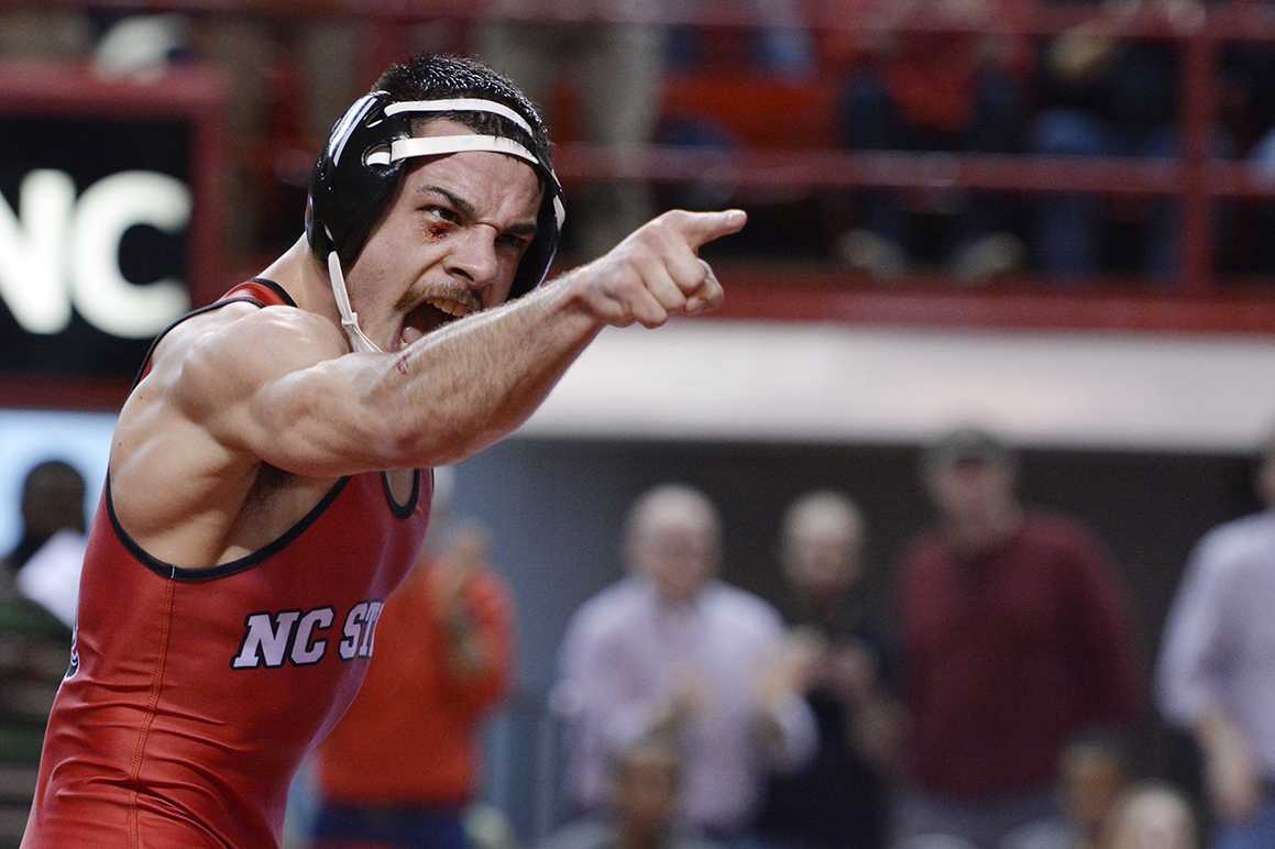 No. 26 redshirt freshman Joe DeAngelo (125 lb.) yells and points to the crowd following his upset win over No. 8 Eddie Klimara during No. 20 NC State's match with No. 6 Oklahoma State Feb. 22, 2015 in Reynolds Coliseum. DeAngelo won the bout by decision 3-2 - 6-9. Despite strong performances by redshirt junior Nick Gwiazdowski and DeAngelo, the Wolfpack was defeated 20-12.