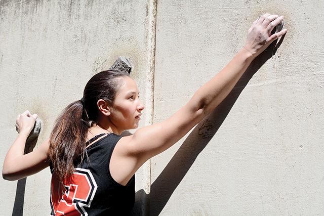 Zoe Harrison, a sophomore studying environmental engineering and member of N.C. State's Competitive Rock Climbing Club, reaches for a rock on the traverse climbing wall at Carmichael Gymnasium. "I really enjoy the club. It's a great bonding experience and a way to make friends" Harrison said. "The best part about rock climbing is that anyone can do it. You don't have to be an amazing athlete or have previous experience. You just have to get on the wall and give it your best effort."