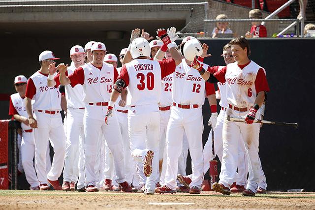 The NC State baseball team exits the dugout to celebrate its fourth home run of the game, as the Wolfpack defeated the Florida State Seminoles, 11-7, in the series closer on Saturday. State dropped its first two games of the series in close contests, but rebounded to top the No. 8 Seminoles thanks to an offensive scoring surge from the team's power hitters.