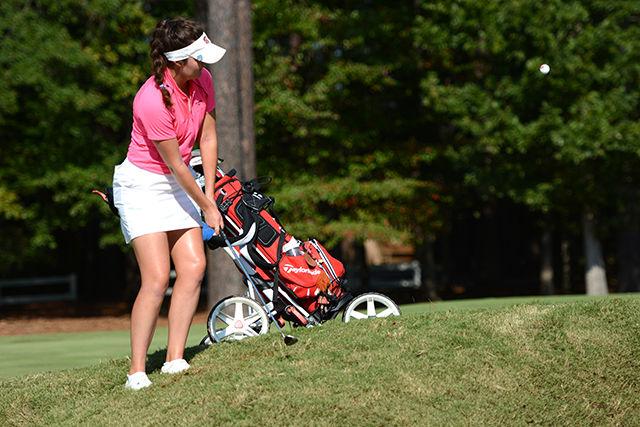 Sophomore Rachael Taylor chips a shot towards the green of hole 1 Saturday, Oct. 11, 2014, during the Ruth's Chris Tarheel Invitational at Finley Golf Course in Chapel Hill. Taylor had her best individual tournament finish of her career shooting 72-71-72 over three days and tieing for 5th overall. The team finished third overall behind Duke and South Carolina. Photo by Caide Wooten.
