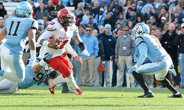 Redshirt junior quarterback Jacoby Brissett runs the ball downfield Nov. 29 at Kenan Stadium. The Wolfpack defeated the Tar Heels 35-7.