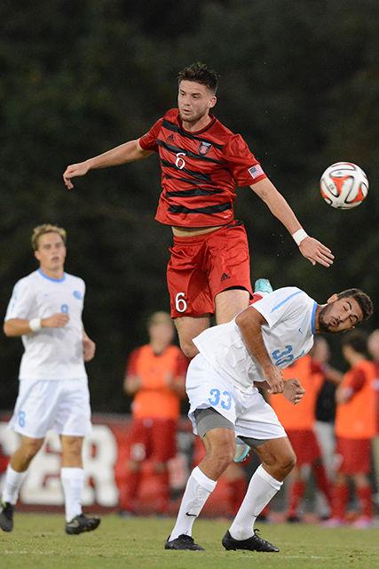 Sophomore midfielder Michael Bajza jumps for a header during the game against UNC-Chapel Hill at Dail Soccer Stadium Oct. 17. The Wolfpack lost to the Tar Heels, 1-0.