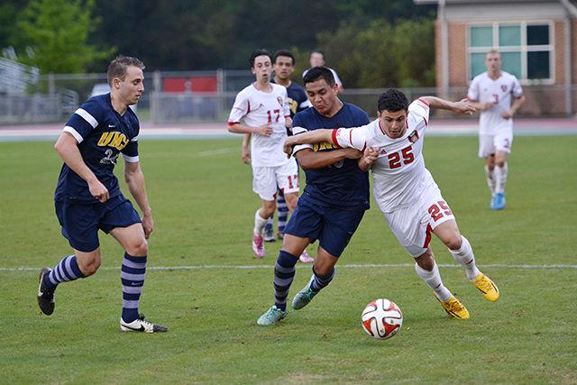Michael Hinkson, sophomore and defender for the Wolfpack soccer team, defends the ball against UNC-Greensboro opponent at the spring game that took place on Saturday at the Dail Soccer Stadium.
