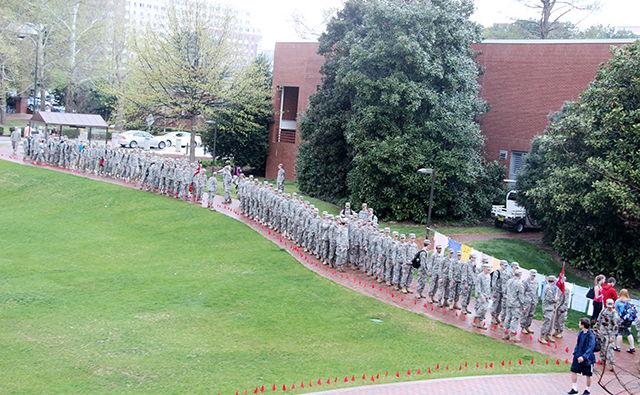US Army ROTC soldiers start to line up alongside the t-shirts made by students raising awareness against sexual assaults outside Witherspoon Student Center for the march at the Take Back the Night event on Thursday, April 9,2015. The march got cancelled because of the inclement weather.