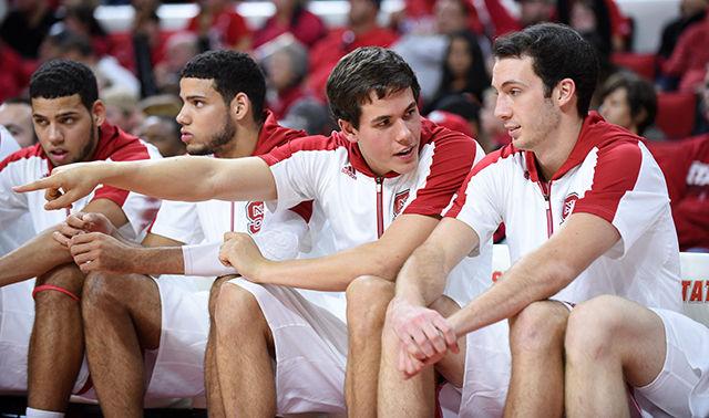 Senior Staats Battle and junior Chase Cannon converse on the bench during the Wolfpack&#8217;s exhibition against Queens University at PNC Arena Nov. 8.