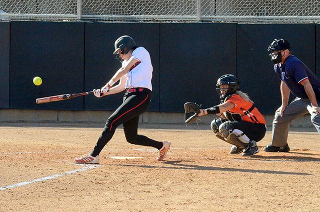 Sophomore catcher Molly Hutchison strikes the ball at Dail Softball Field on Oct.19. Hutchinson drove in two runs on a double in the third inning of the game. The Wolfpack defeated Campbell 4-0 in game one and 1-0 in game two.&#160;