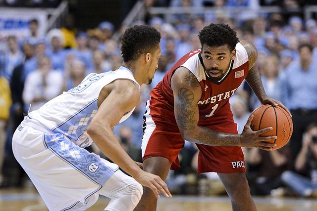 Redshirt junior guard Trevor Lacey pauses at the top of the key while being guarded by North Carolina's J.P. Tokoto Tuesday, Feb. 24, 2015, at the Dean E. Smith Center. Lacey finished with 14 points, 6 rebounds, 4 assists, and 2 steals in the Wolfpack's 58-46 win over the Tar Heels. The victory was the Wolfpack's first at UNC since 2003, and its first over a Roy Williams-led Tar Heel squad.