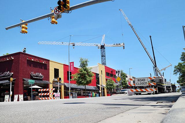 Hillsborough Street was shut down on Sunday June 6th in ordernn to erect cranes. One crane remains in the lot which once held two guys pizza as it continues to help build supports for a new structure. This construction is but one example of many construction sites occuring both on and adjacent to NC States campus.