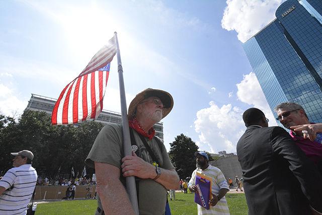 Bob Feldman, a native of Asheville and a member of Chapter 99 of Veterans for Peace, patroling with the American flag at the site of the Voting Rights rally in downtown Winston-Salem on Monday. Feldman was a member of the Vietnamese Navy during the Vietnam War where he was tasked with checking fishing boats for weapons. For Feldman, the rally was a "show of solidarity" with the community. Feldman said that one of the issues that leads to restrictions on voting rights is confusing capitalism with democracy. "It's not democratic!" Feldman said. photo by Gavin Stone