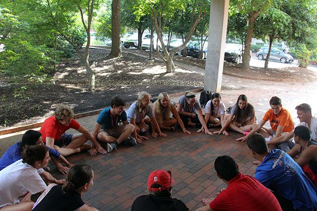Every day, the orientation groups take a little detour from getting to know the campus and sit around in circles on the corridor in front of Burlington Hall and spend some time chatting, playing a game or asking orientation leaders some questions. One of these many orientation groups play slap hands and make the orientation a little more fun. New student orientations have been taking place all summer to help incoming freshmen to prepare for the new chapter of their life. Bobby Scanlon, an incoming first-year studying life sciences says, "I have learned a lot from orientation and I think I'm ready to start this fall. Orientation leaders are really nice and helpful."
