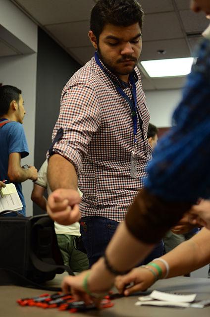 A participant from the Iraqi Young Leaders Exchange Program (IYLEP) picks up Technician pens and stickers after learning about the role of the newspaper on campus Thursday, August 13, 2015. The IYLEP is a fully-funded scholarship program in the U.S. that allows Iraqi high school students and adult mentors to build leadership skills to strengthen the future of Iraq and the U.S.