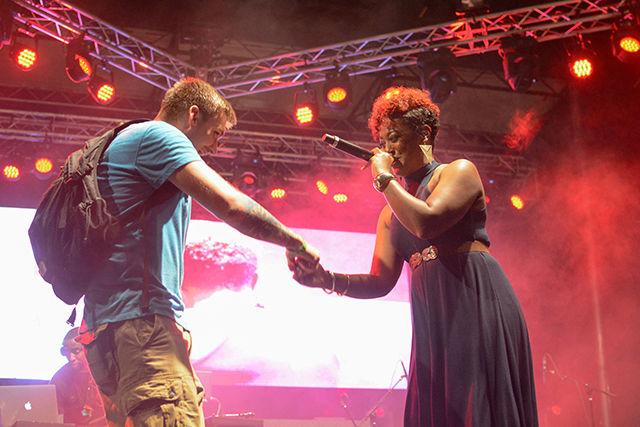 Rapsody greets crowd member Steven Haley after bringing him onstage.