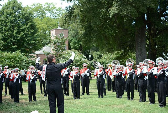 Conductor Michael Scanlan, a senior studying Meterology, leads the marching band in warm ups.
