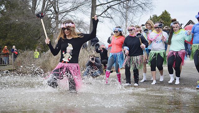 Representatives of the Youth Activation Council of Special Olympics North Carolina run into the frigid water of Lake Raleigh Saturday morning, Feb. 21, 2015 at the 2015 Polar Plunge. Dozens of "plungers" braved the nearly-freezing water during the annual event hosted to raise funds for Special Olympics North Carolina. This year's groups raised more than $14,000 for the cause.