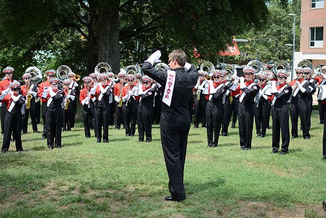 Conductor Michael Scanlan, a senior studying Meterology, leads the marching band in warm ups.