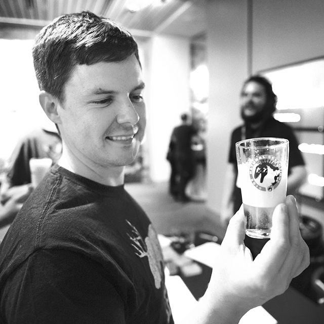 NC State fan and craft beer enthusiast Dustin Brewer, analyzing the color and consistency of his mystery beer at the Sheppard Brewing Lab's table during the Natural Selections beer tasting event on Friday.