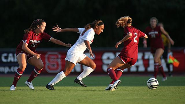 Freshman forward Maxine Blackwood charges toward to ball overtaking two South Carolina players. Blackwood had two shots on goal during exhibition game against #11 South Carolina. The Pack lost the match 0-3 on August 14th at Dail Soccer Stadium.