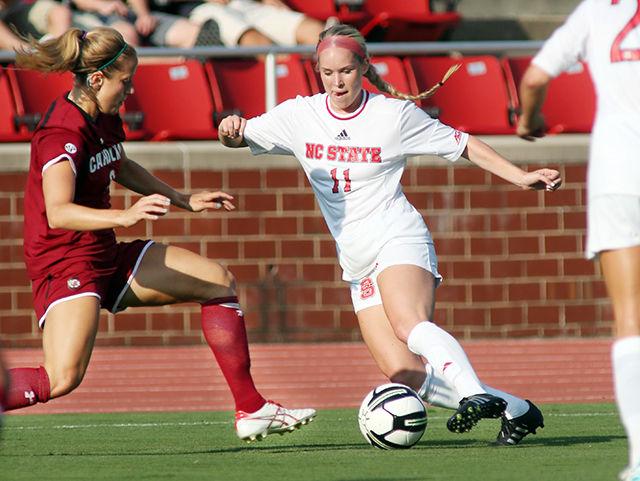 Senior midfielder Brittany Stanko makes a move around a South Carolina defender. The Wolfpack lost the exhibition game 0-3 to #11 USC on Augsut 14th in Dail Soccer Stadium.