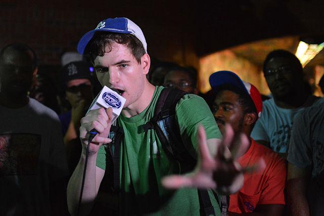 Anderson Burrus, a senior studying mass media communication, performs a freestyle rap in front of the Free Expression Tunnel during the NC State Cypher's 5 year anniversary on Monday night. Burrus has been rapping for 7 years, and he discovered the Cypher 3 years ago. He said, "The Cypher is a demonstration of what hip hop is designed to be. It's a safe environment where anyone is allowed to express themselves in any way they want. That's the side of hip hop very few people see anymore, and it's the image we try to promote every Monday night."