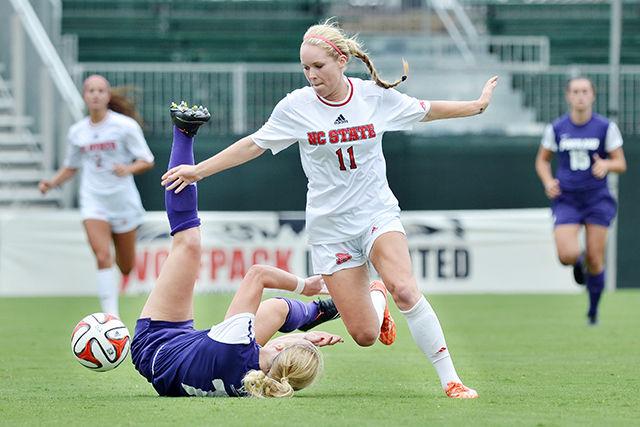 Junior forward Brittany Stanko pushes down a Portland player for possession of the ball Sunday, August 28, 2014. Stanko had the Wolfpack's only assist in their 2-1 loss to the No. 11 Pilots at Dail Soccer Field.&#160;
