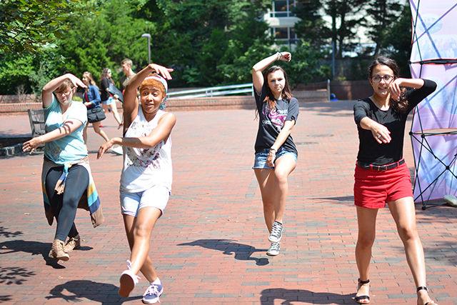 Just Cuz Crew members Holly Fischer, a junior studying geology and design studies, Destinee Gray, a junior studying animal science, Morgan Huth, a senior studying business administration, and Erin Wiley, a junior studying accounting perform a dance choreography in Wolf Plaza Tuesday. "JCC is an NCSU student organization where we share and spread our love and passion for dance to students who are interested. No experience is required. We usually hold community classes every month where we teach a choreography piece to students who want to come learn."