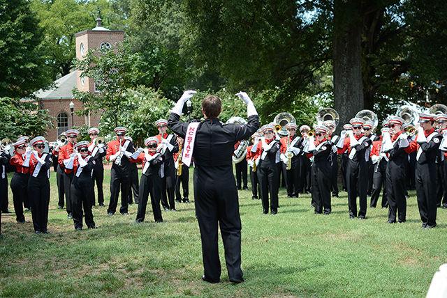 Conductor Michael Scanlan, a senior studying Meterology, leads the marching band in warm ups.