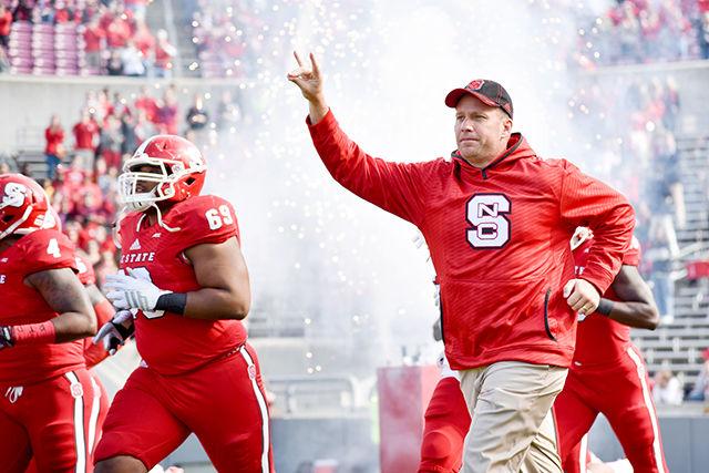 Head coach Dave Doeren takes the field before the homecoming football game against Georgia Tech in Carter-Finley Stadium Saturday, Nov. 8, 2014. The Wolfpack's two season drought of home conference wins continued with a 56-23 loss to the Yellow Jackets.