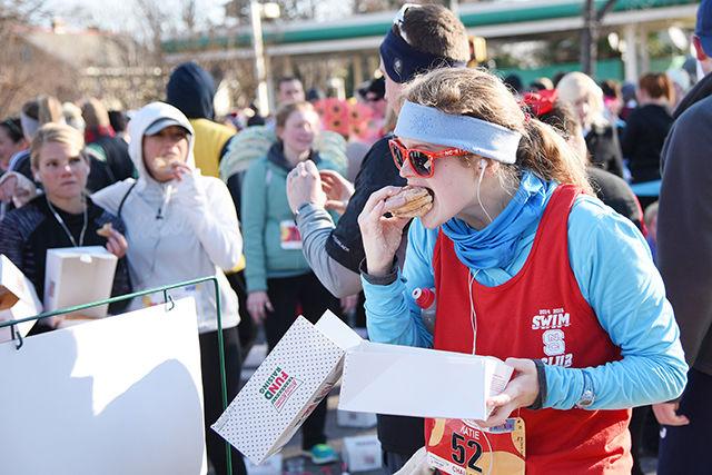 Katie Baldwin, of Raleigh, NC, eats a triple stack of donuts outside of Krispy Kreme during the Krispy Kreme Challenge in Raleigh Saturday, Feb. 14, 2015.
