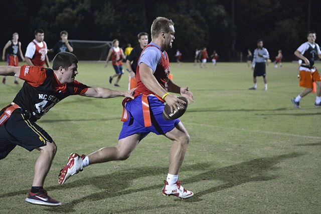 Mike Roach, a senior studying Aerospace Engineering, runs away from opponent Ben Beeson, a sophomore in Management, during an intramural flag football game. Students got together on Sept. 14th on Miller Field to play a variety of intramural sports. Roach commented on his intramural flag football experience by saying "I wanted to play intramural sports to hang out with my friends and have school spirit."