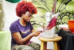 Lakeesha Fradella, the owner of Martian Creations, carefully glues yarn onto a unicorn bust on 9/19. Fradella started Martian Creations to combine her love for crocheting and her eccentric artistic style. This was her 3rd year coming to SPARKcon. The bazzarSPARK section of SPARKcon was reserved for local artisans and vendors.