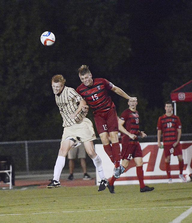Sophomore midfielder Cameron Steele heads the ball with Charleston Cougar Lorenz Esposito. Steele had two shots on goal during State's first regular season home game Aug. 31. The Wolfpack won 2-0 at Dail Soccer Stadium.