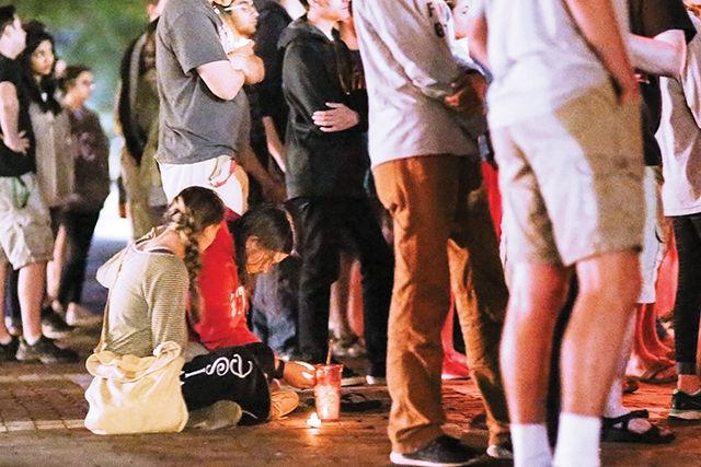 Leanna Beach, a senior studying technology education, comforts sophomore mechanical engineering major Cayla Cooke during the candlelight vigil held on the Brickyard Sept. 14. Beach said that she urges people to ask how others are doing, as that may be all it takes to get them to open up.