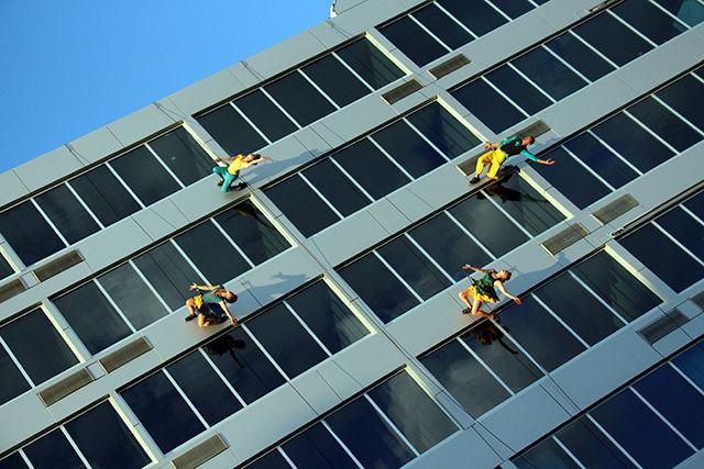 The performers of the group Bandaloop, performs at their free event which was a part of SparkCon and was organized by NC State Live. Bandaloop, a pioneer in vertical dance performance, seamlessly weaves dynamic physicality, intricate choreography and the art of climbing to turn the dance floor on its side, performs at the Aloft Hotel, in front of Bell Tower at Hillsborough street on Saturday, September 20, 2015.
